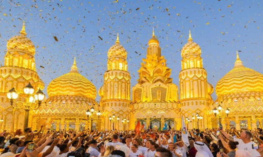 A vibrant cultural pavilion lit up at night in Global Village Dubai, featuring intricate designs and colorful lights.